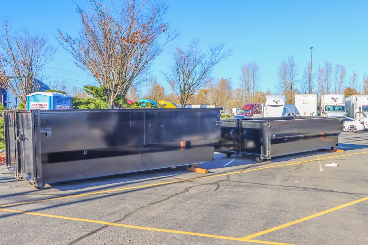 Professional dumpster rental service with roll-off container on residential driveway in Castro Valley